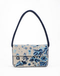 Kooks blue floral beaded shoulder bag - front view showing scattered blue botanical beadwork on ivory ground with navy beaded strap